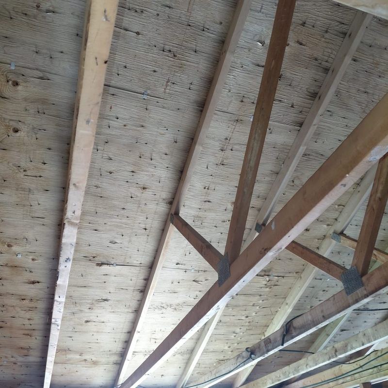 The same style of plank sheathing after remediation, back to clean bare wood