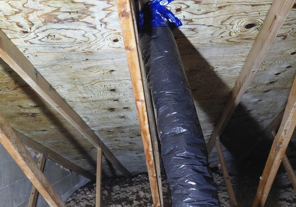 Cleaned attic sheathing with a new insulated exhaust duct properly routed to outside